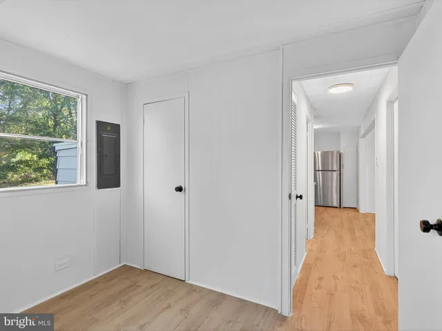 a view of a room with wooden floor and windows