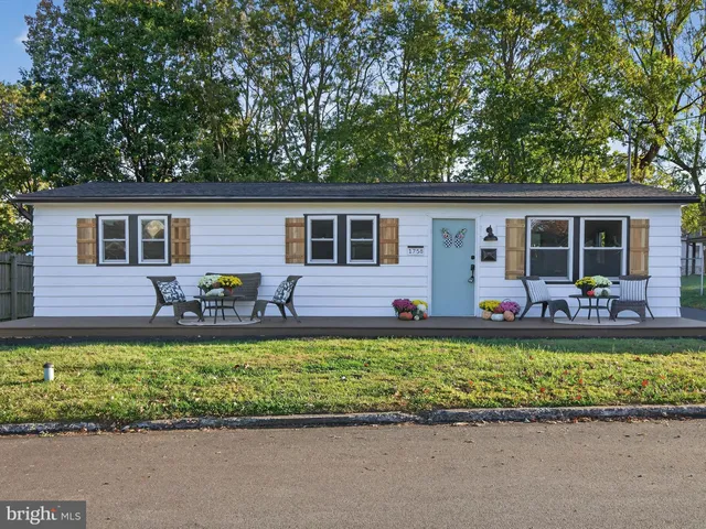 a view of a house with a patio and a garden