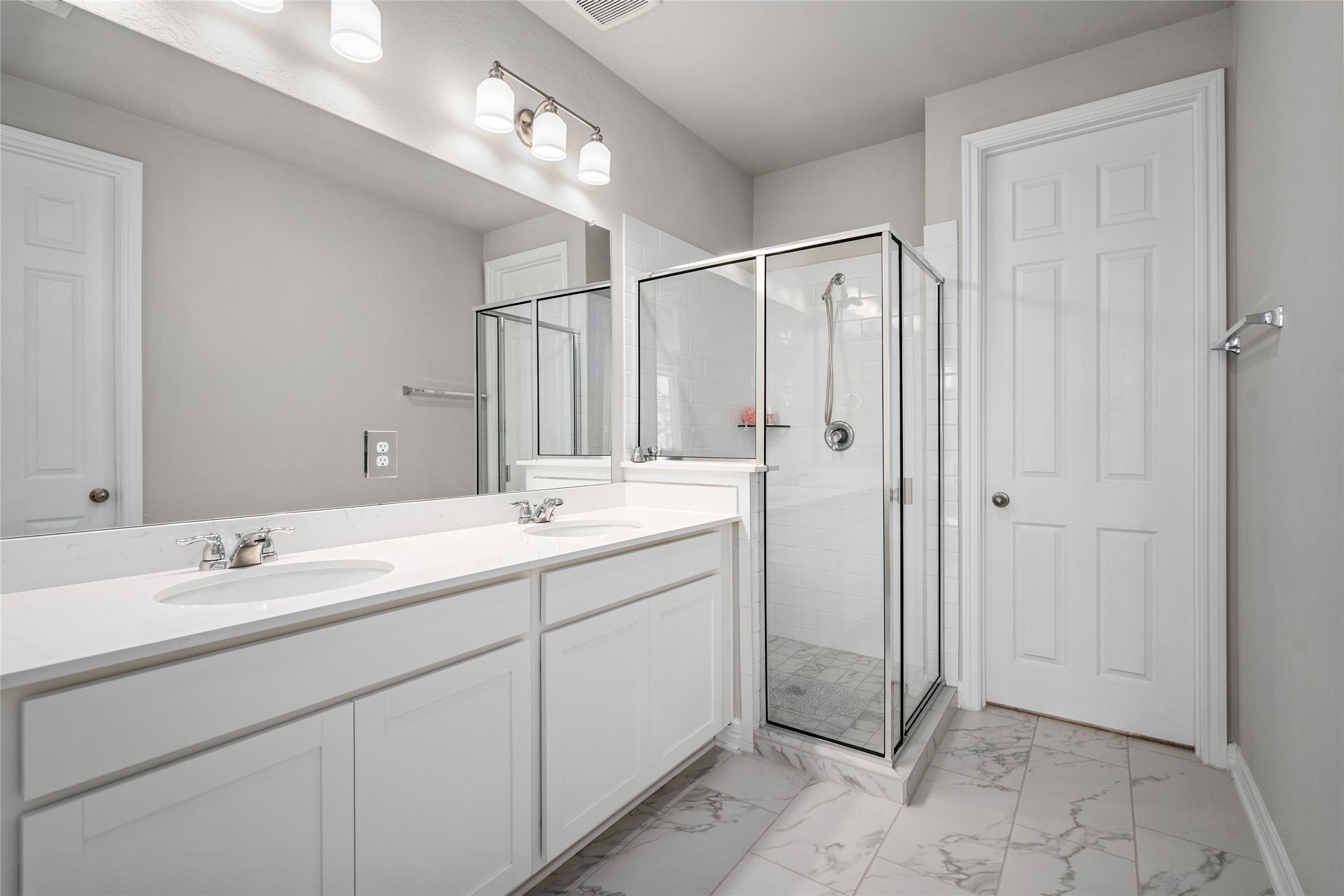 9406 Caddo Ridge Lane Cypress, TX 77433 - Photo 10 of 25 Spacious primary with double sinks, great light and walk-in shower.