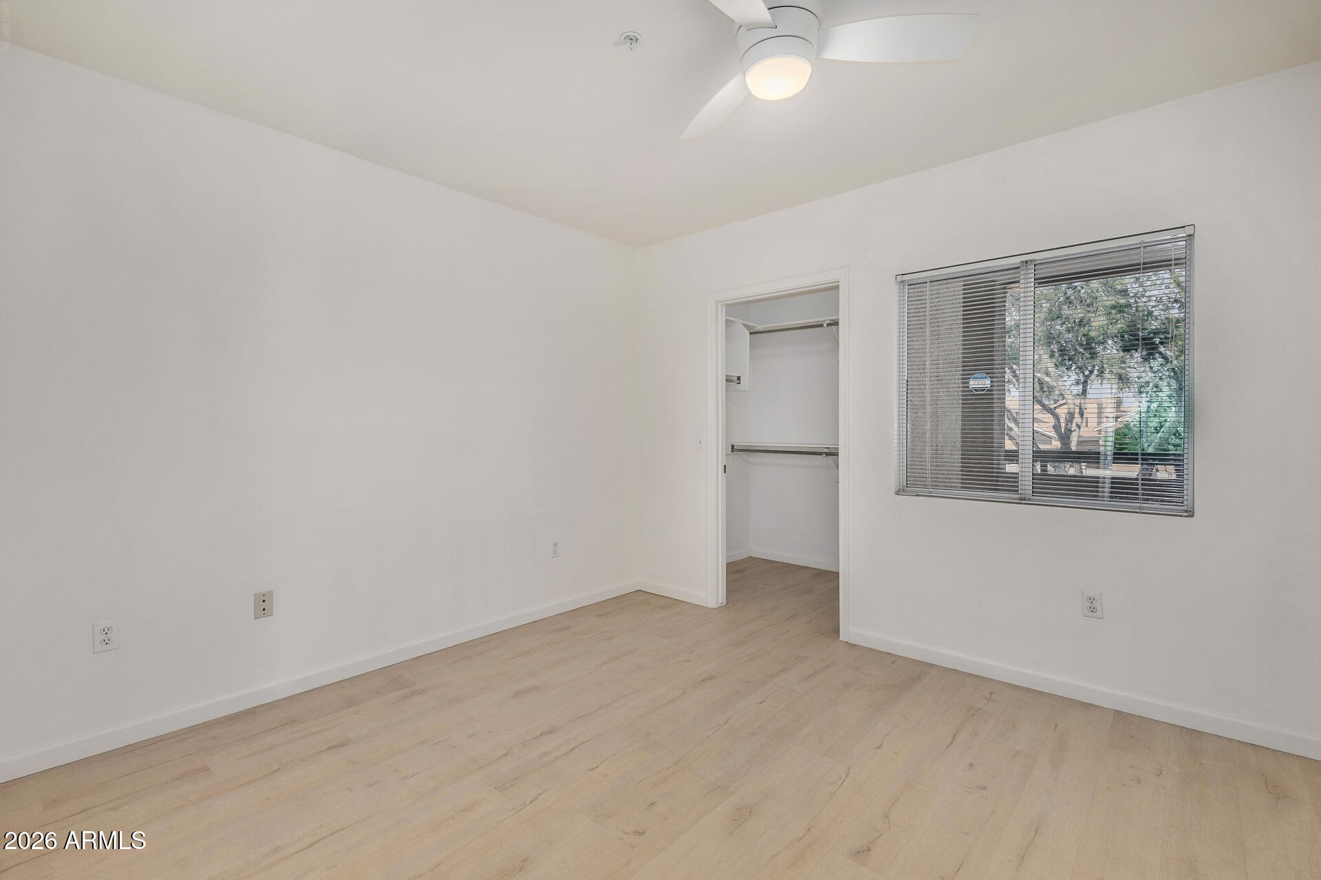 1295 North Ash Street, Unit 828 Gilbert, AZ 85233 - Photo 20 of 43 an empty room with a window and a ceiling fan
