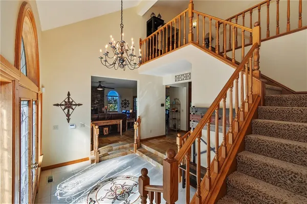 a living room with furniture a fireplace and a floor to ceiling window
