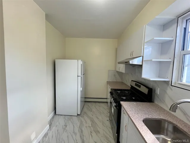 a kitchen with a refrigerator and a sink