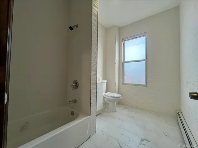 a bathroom with a toilet and shower