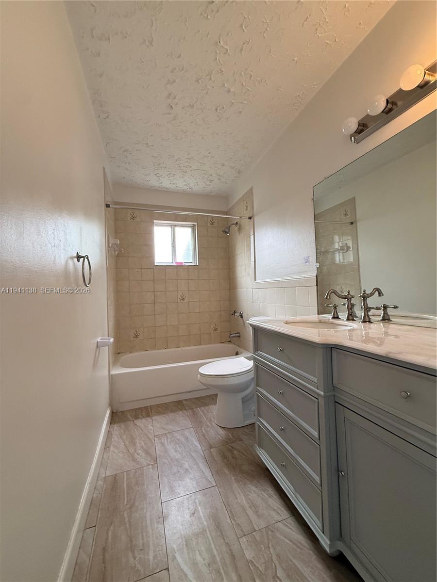 13628 Southwest 287th Lane Homestead, FL 33033 - Photo 16 of 17 a bathroom with a sink a toilet and a bathtub