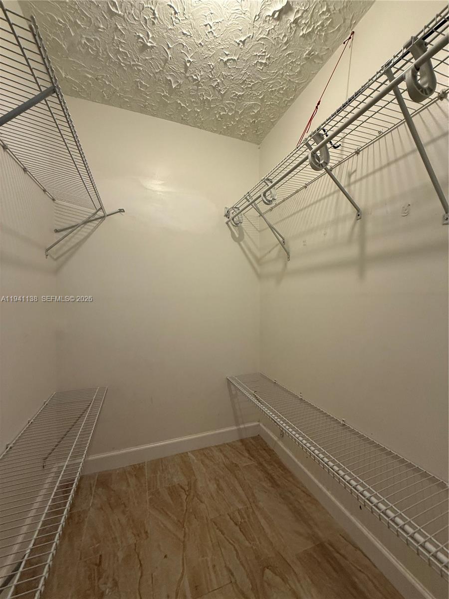 13628 Southwest 287th Lane Homestead, FL 33033 - Photo 5 of 17 a view of a room with racks on the wall