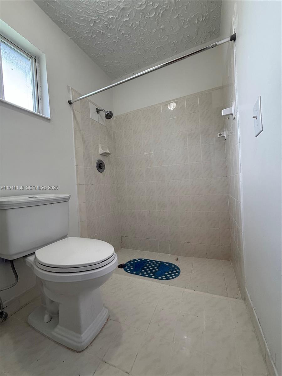 13628 Southwest 287th Lane Homestead, FL 33033 - Photo 8 of 17 a bathroom with a toilet and a shower