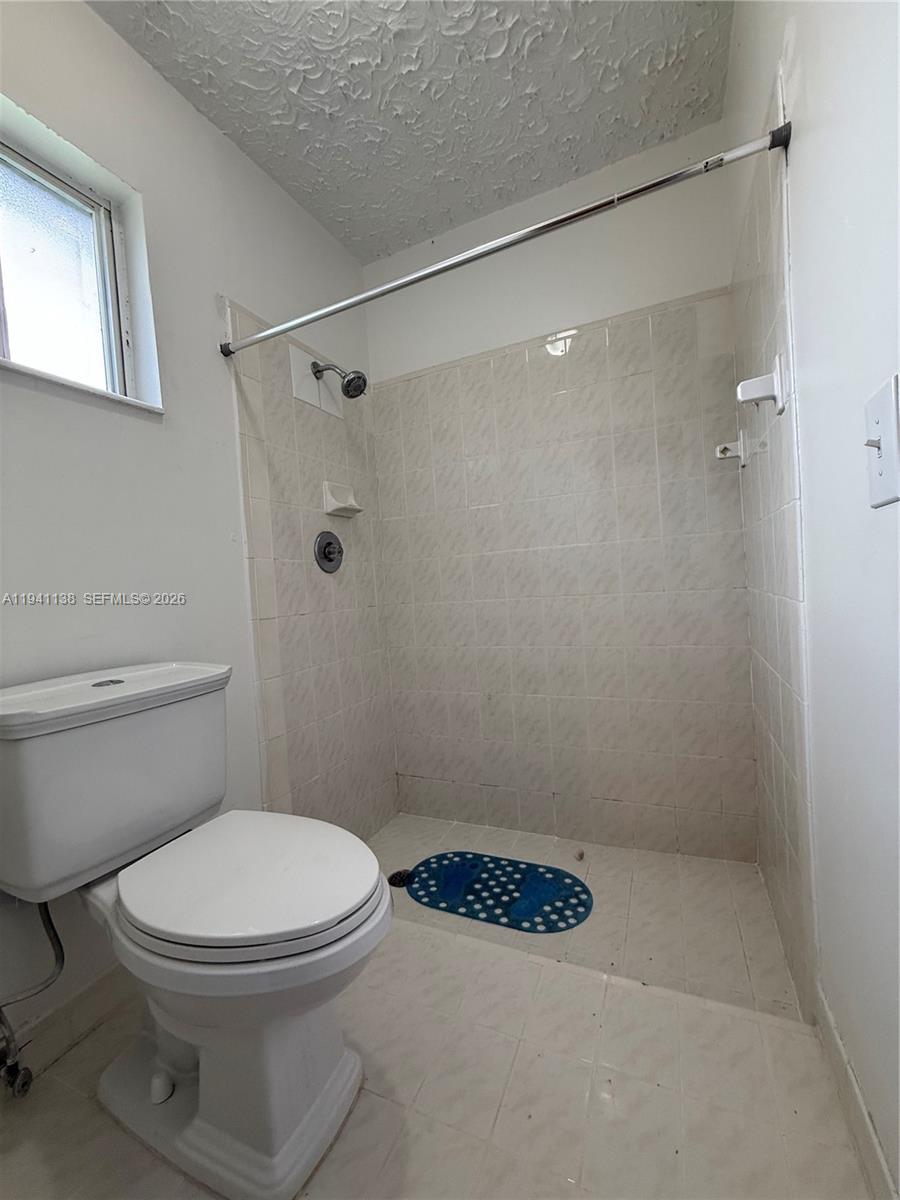 13628 Southwest 287th Lane Homestead, FL 33033 - Photo 9 of 17 a bathroom with a toilet and a shower