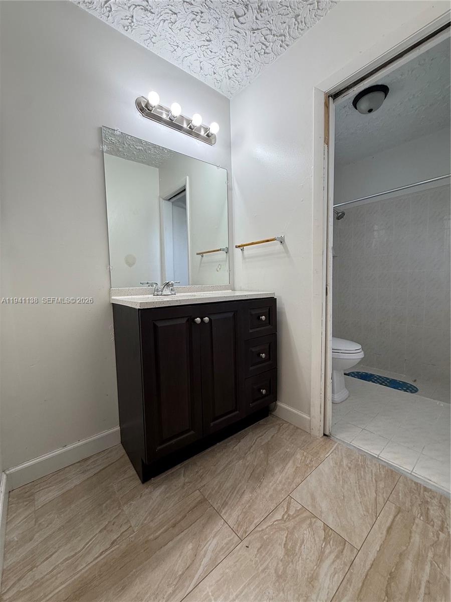 13628 Southwest 287th Lane Homestead, FL 33033 - Photo 10 of 17 a spacious bathroom with a sink and a mirror