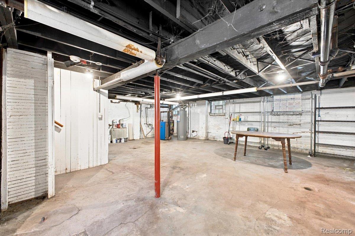899 Edison Street Detroit, MI 48202 - Photo 31 of 37 Unfinished basement with concrete flooring and painted brick walls