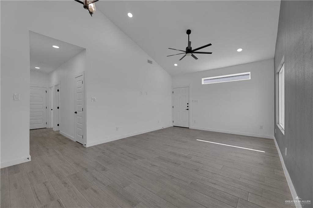 2509 Mockingbird Road, Unit B Weslaco, TX 78596 - Photo 6 of 11 Empty room featuring ceiling fan, high vaulted ceiling, and light hardwood / wood-style floors
