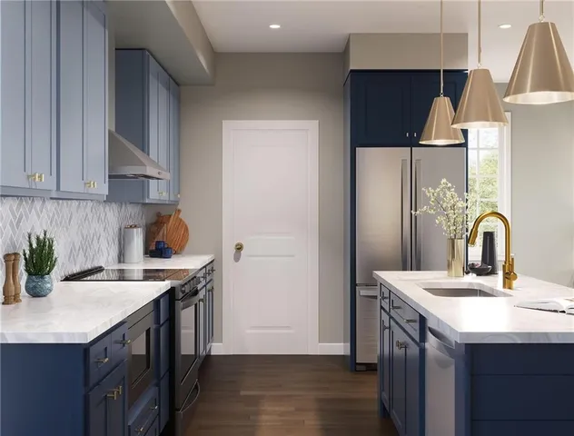 a kitchen with a sink a refrigerator and cabinets