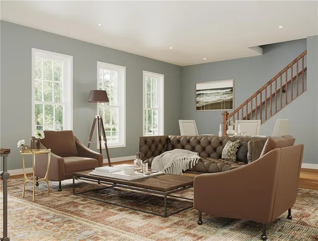 a living room with furniture and a potted plant