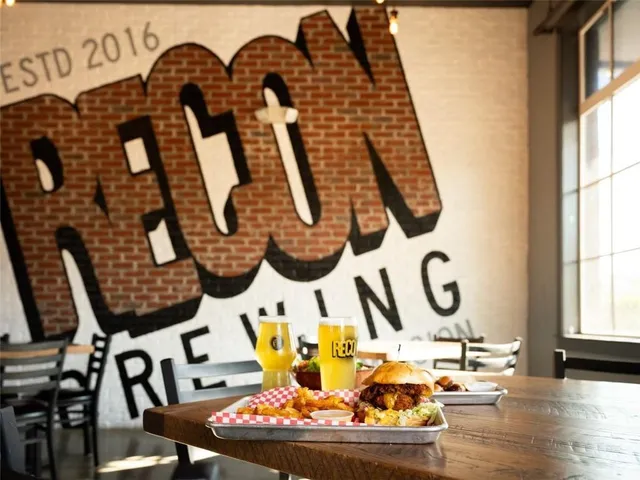 a room with lots of white furniture and painting on the wall