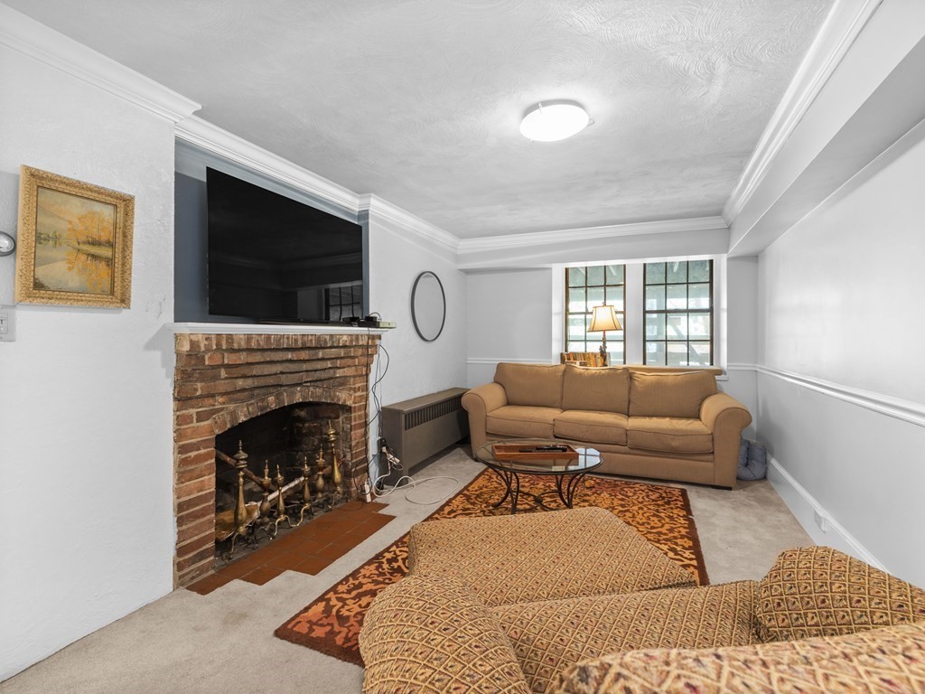 37 Crehore Road Boston, MA 02467 - Photo 16 of 30 a living room with furniture a flat screen tv and a fireplace