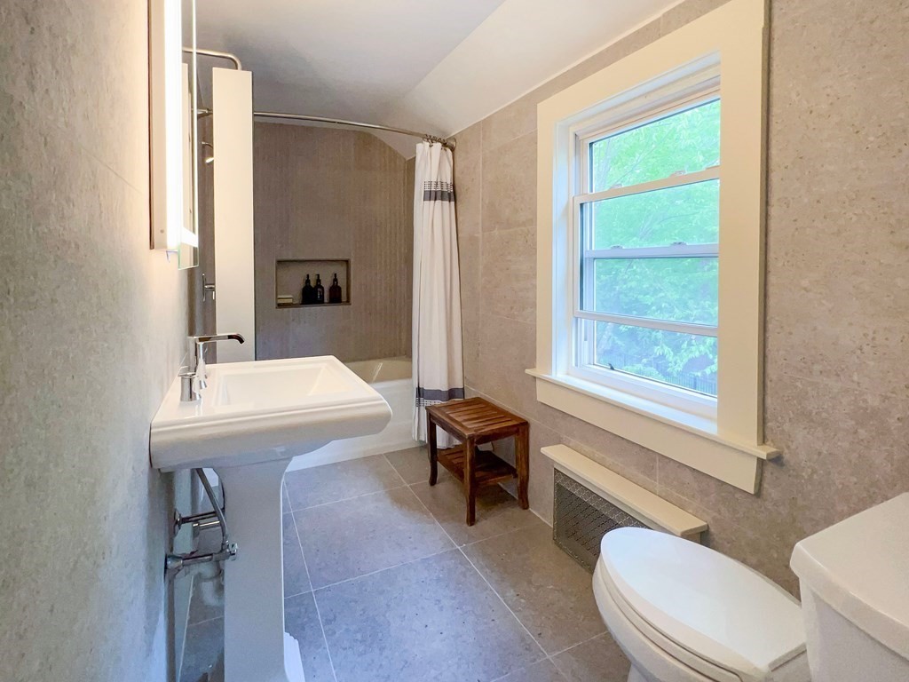 37 Crehore Road Boston, MA 02467 - Photo 18 of 30 a bathroom with a sink and a mirror