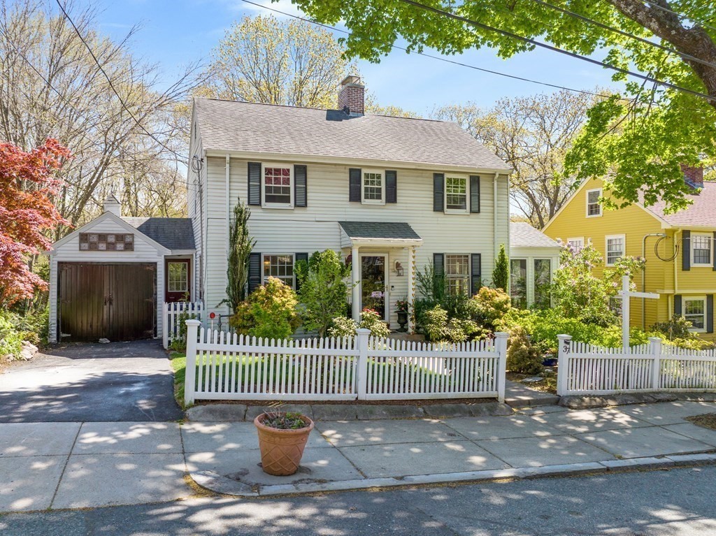 37 Crehore Road Boston, MA 02467 - Photo 25 of 30 a front view of a house with a garden and plants