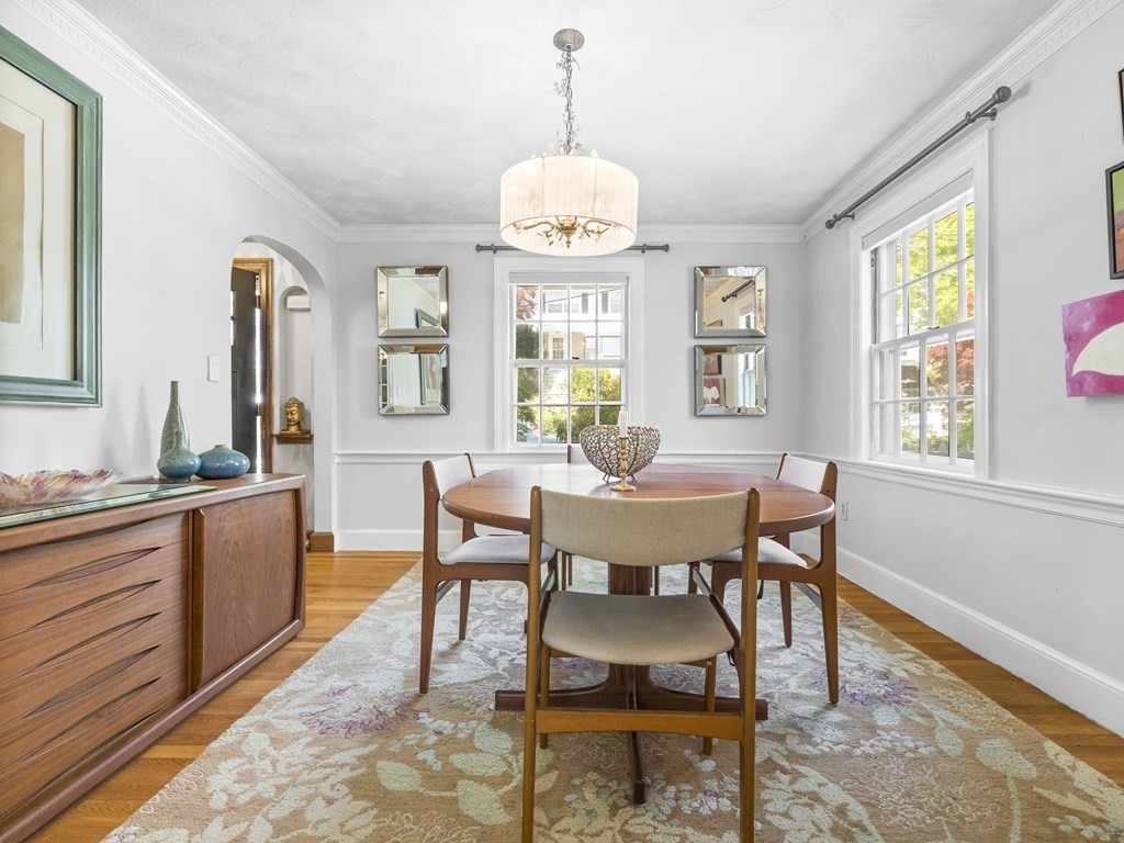 37 Crehore Road Boston, MA 02467 - Photo 6 of 30 a dining room with wooden floor a chandelier a wooden table and chairs