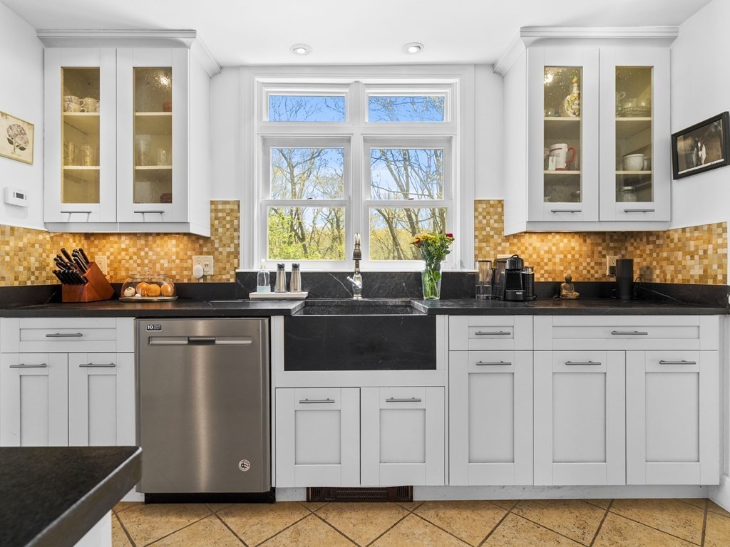 37 Crehore Road Boston, MA 02467 - Photo 8 of 30 a kitchen with stainless steel appliances granite countertop a sink and a white cabinets
