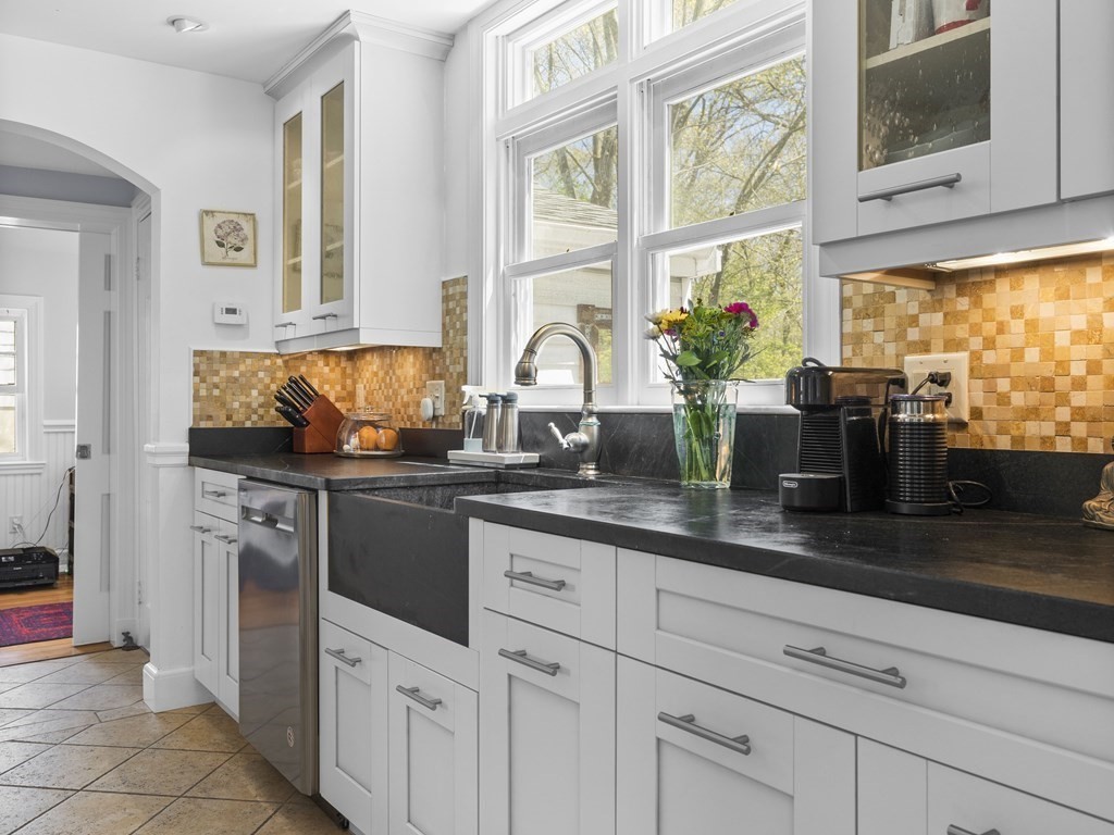 37 Crehore Road Boston, MA 02467 - Photo 9 of 30 a kitchen with stainless steel appliances granite countertop a stove a sink and a microwave