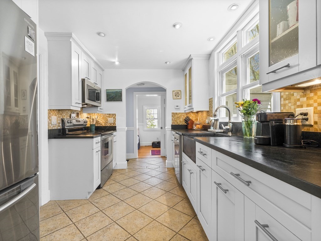 37 Crehore Road Boston, MA 02467 - Photo 10 of 30 a kitchen with granite countertop a refrigerator and a sink