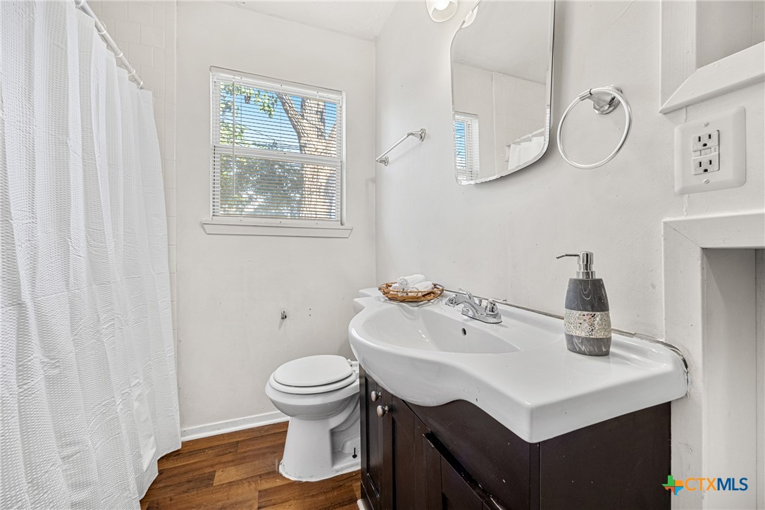13 North 41st Street Temple, TX 76504 - Photo 11 of 20 a bathroom with a sink toilet and a mirror