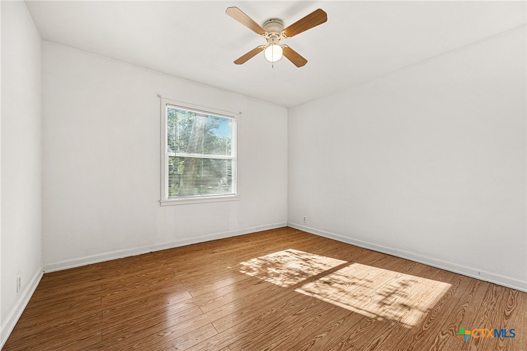 13 North 41st Street Temple, TX 76504 - Photo 13 of 20 wooden floor in an empty room with a window