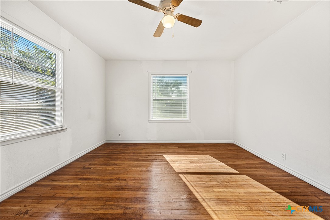 13 North 41st Street Temple, TX 76504 - Photo 14 of 20 wooden floor in an empty room with a window