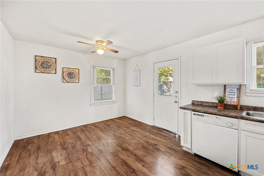 13 North 41st Street Temple, TX 76504 - Photo 8 of 20 a kitchen with granite countertop a stove a sink and a window