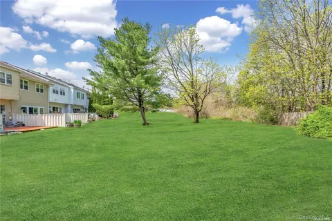 a view of house with backyard