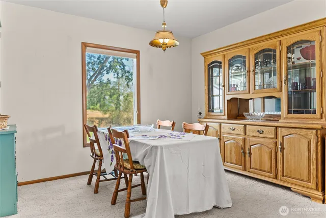 a dining hall with stainless steel appliances granite countertop furniture and a window
