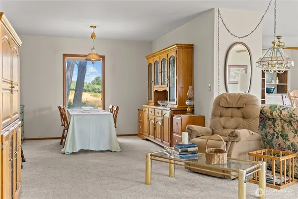 a living room with furniture a window and a chandelier