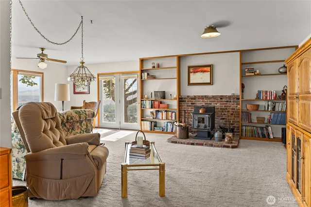 a living room with furniture a ceiling fan and a window