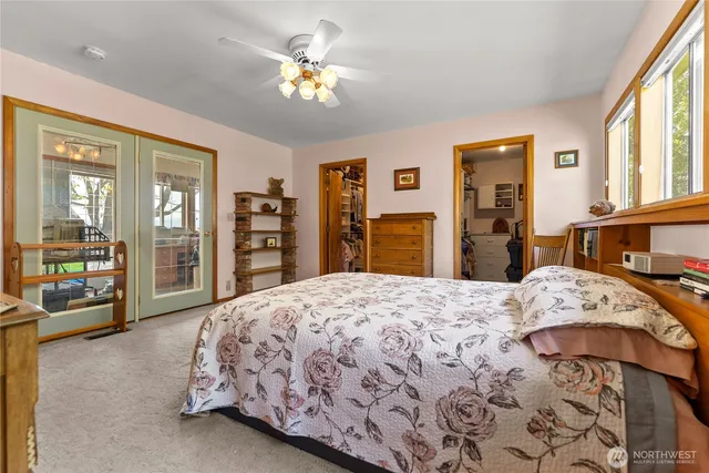 a bedroom with a large bed and a dresser