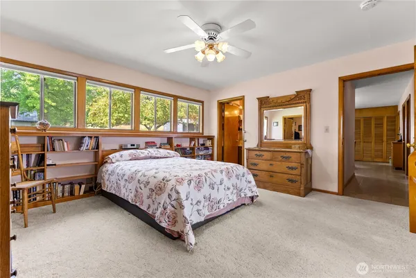 a spacious bedroom with a bed and a chandelier