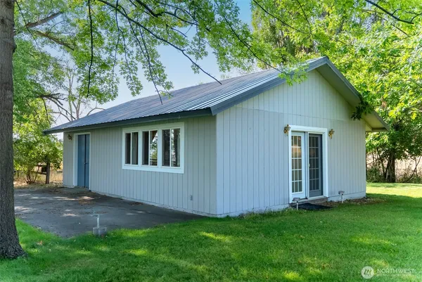 a room with pool table and windows