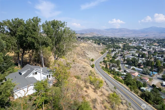 an aerial view of a house with yard and roof