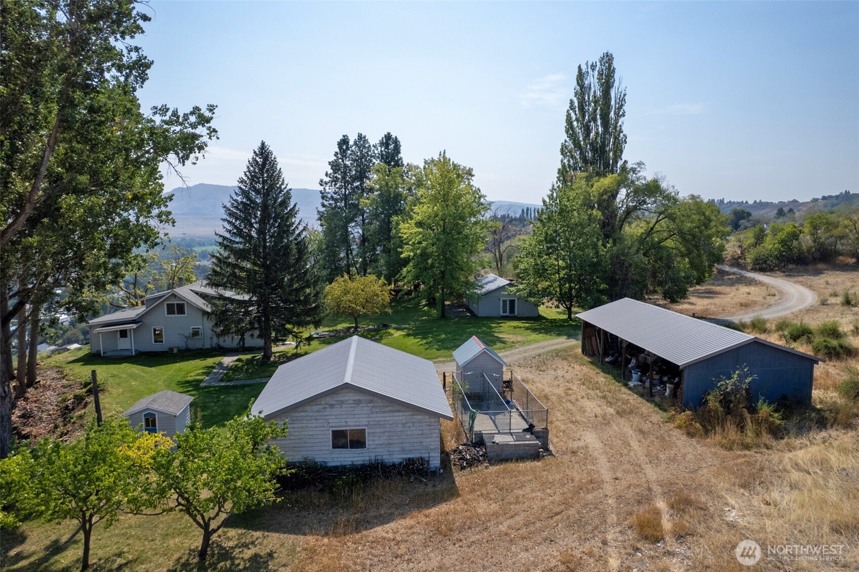 14 Dalton Road Omak, WA 98841 - Photo 37 of 37 an aerial view of a house with yard and roof