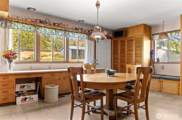 a view of a dining room with furniture window and outside view