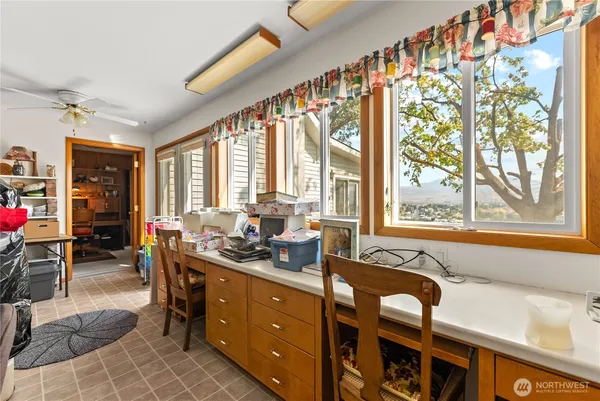 a room with lots of wooden furniture and windows