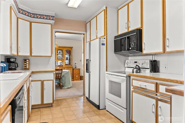 a kitchen with stainless steel appliances granite countertop a refrigerator and a stove top oven