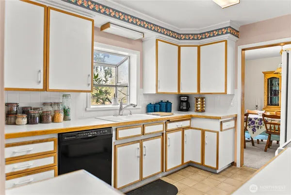 a kitchen with stainless steel appliances a sink and cabinets
