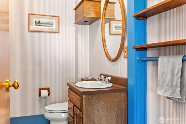 a bathroom with a toilet a sink and mirror