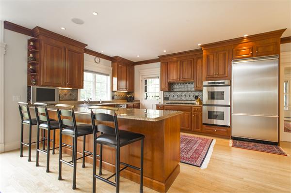 22 Chestnut Hill Road Newton, MA 02467 - Photo 8 of 30 a kitchen with granite countertop a refrigerator stove top oven dining table and chairs