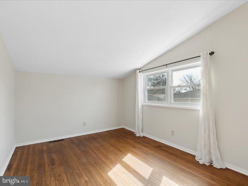 437 Haywood Road Ambler, PA 19002 - Photo 12 of 14 an empty room with wooden floor and windows