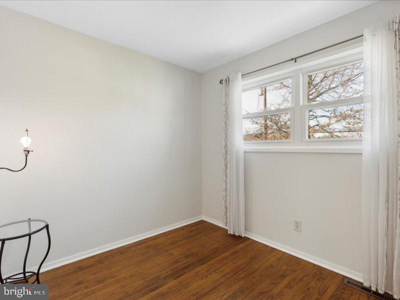 437 Haywood Road Ambler, PA 19002 - Photo 13 of 14 an empty room with wooden floor and windows