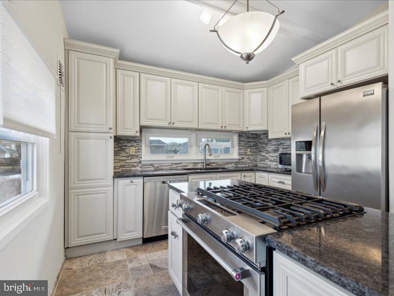 437 Haywood Road Ambler, PA 19002 - Photo 2 of 14 a kitchen with stainless steel appliances granite countertop a stove a refrigerator and a granite counter tops