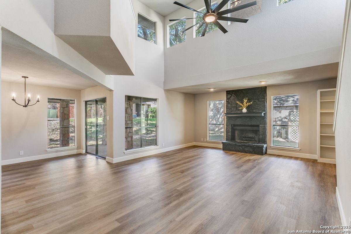 9380 Braun Road, Unit 501B San Antonio, TX 78254 - Photo 11 of 29 a view of an empty room with wooden floor and a ceiling fan