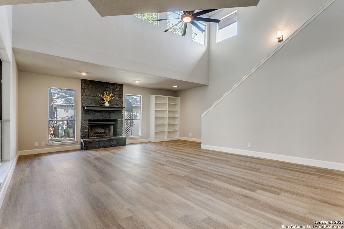 9380 Braun Road, Unit 501B San Antonio, TX 78254 - Photo 12 of 29 a view of empty room with wooden floor and fireplace