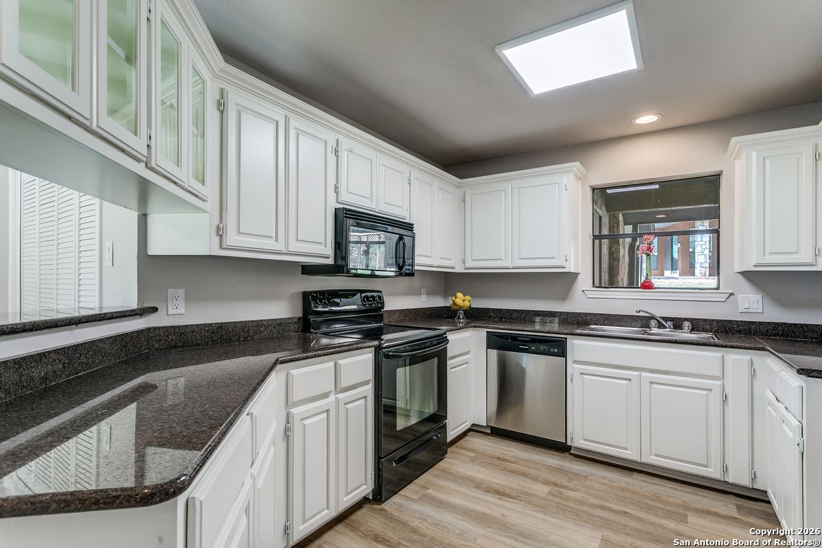 9380 Braun Road, Unit 501B San Antonio, TX 78254 - Photo 13 of 29 a kitchen with stainless steel appliances granite countertop white cabinets sink and stove