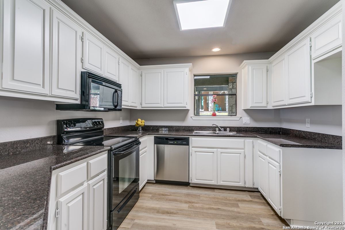 9380 Braun Road, Unit 501B San Antonio, TX 78254 - Photo 14 of 29 a kitchen with stainless steel appliances granite countertop a stove a sink and a microwave